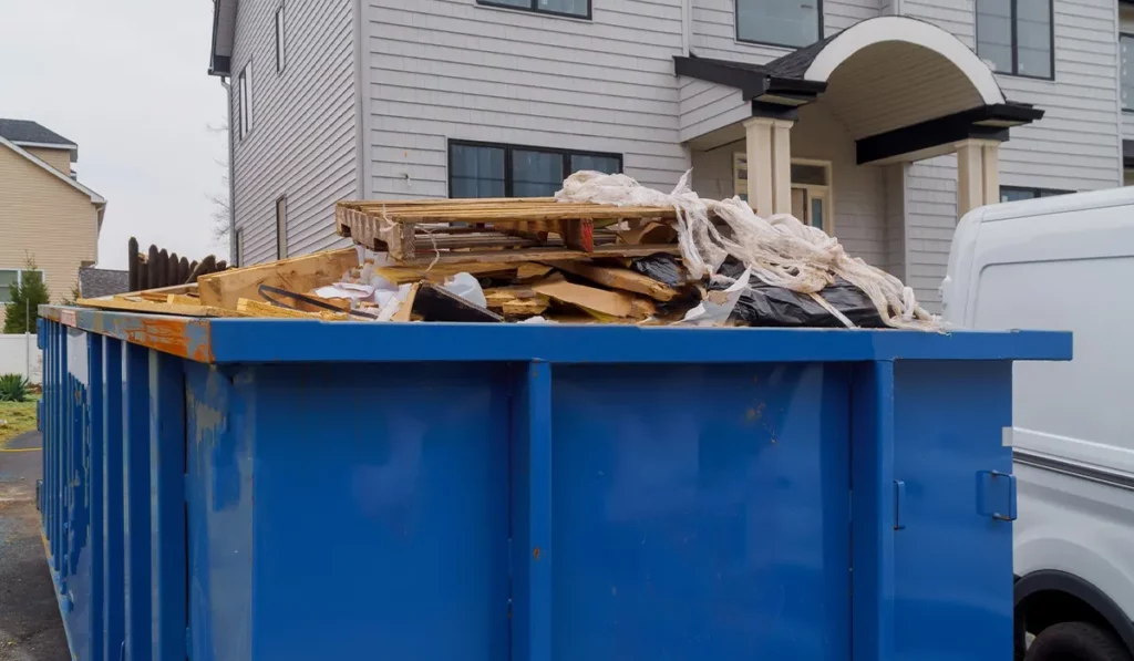filled dumpster in front of home renovation in Fort Collins
