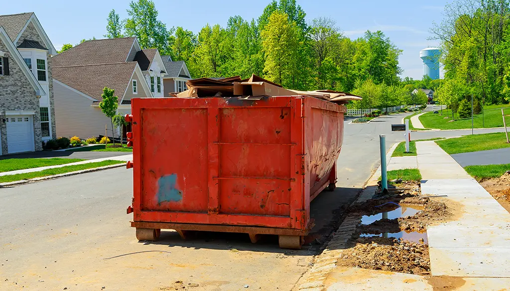 filled dumpster on residential street